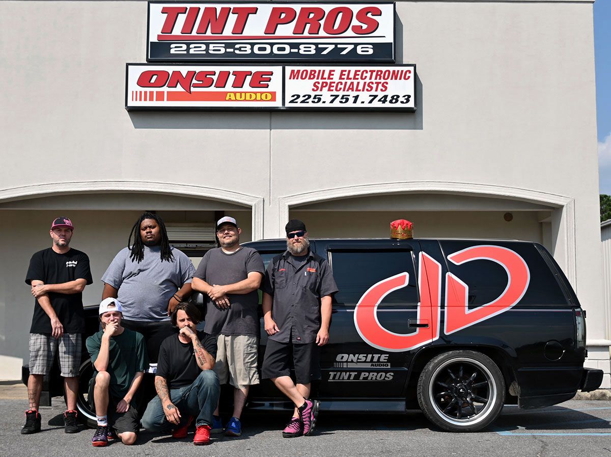 Photo of Onsite store front with custom DD van and shop staff