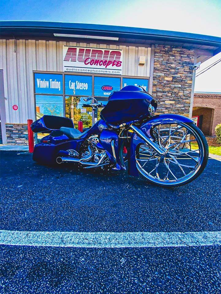 Photo of motorcycle in front of Audio Concepts storefront