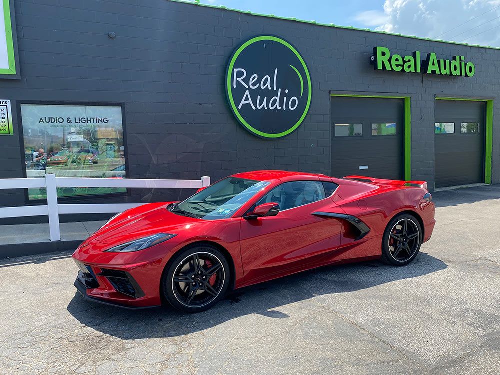 Photo of Real Audio store front with car in shot