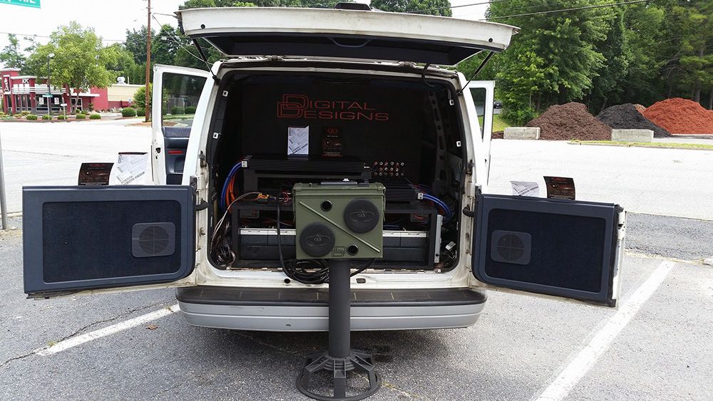 photo of Bryant Radio custom ammo can speaker box in front of custom install van