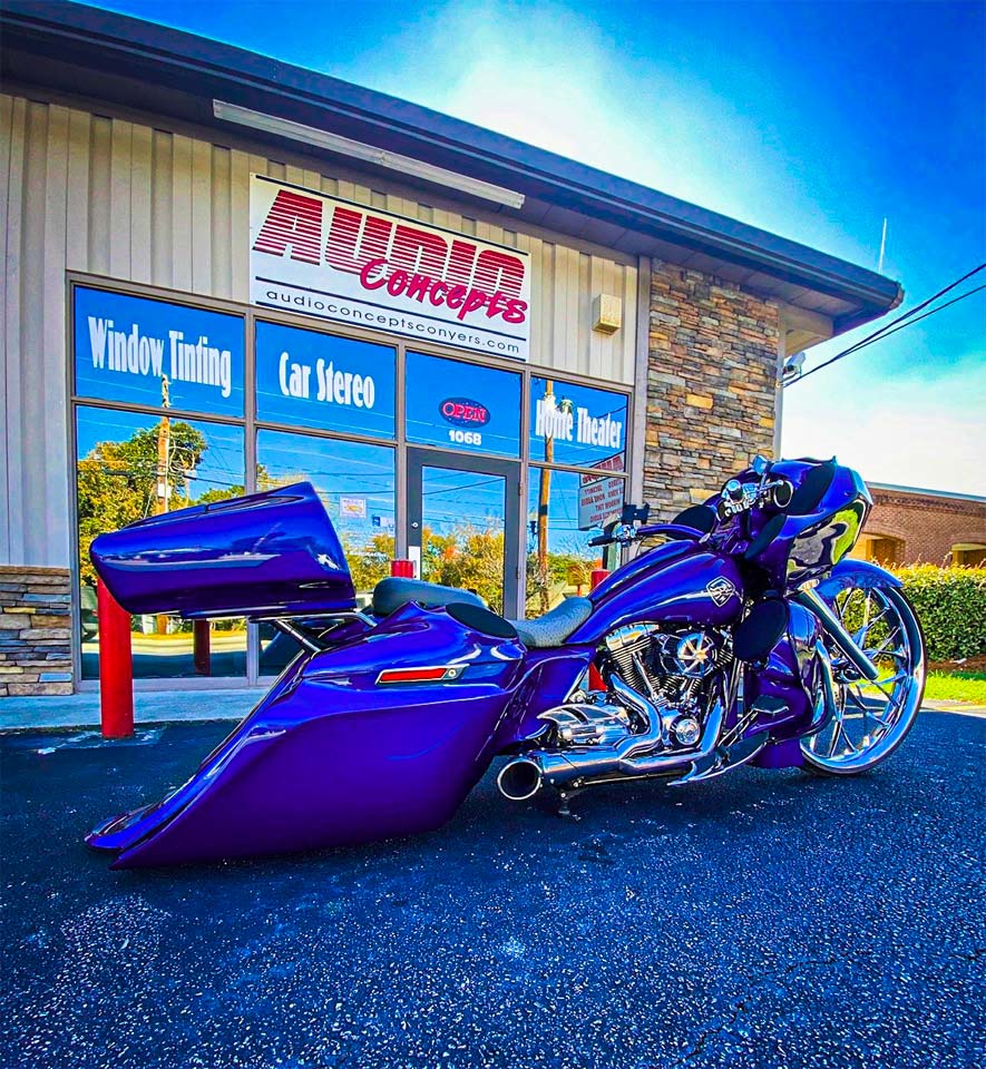 Photo of motorcycle in front of Audio Concepts storefront