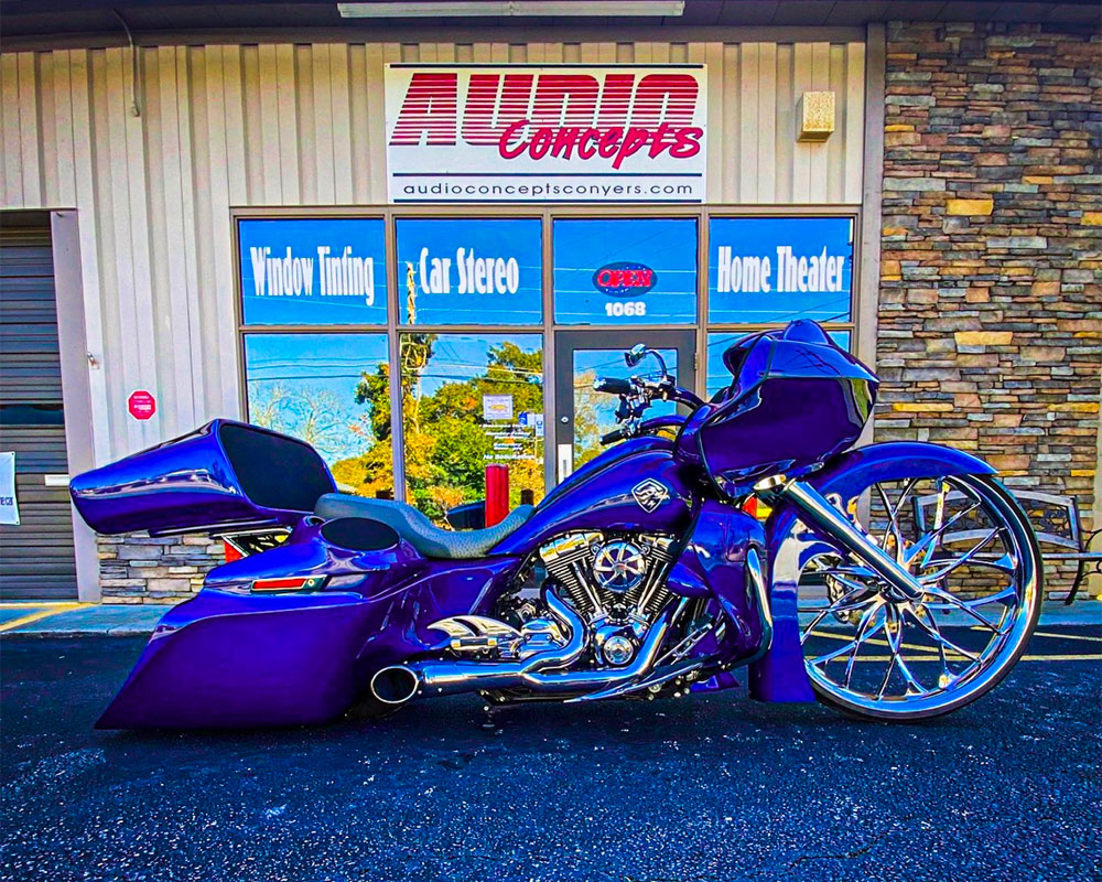 Photo of motorcycle in front of Audio Concepts storefront