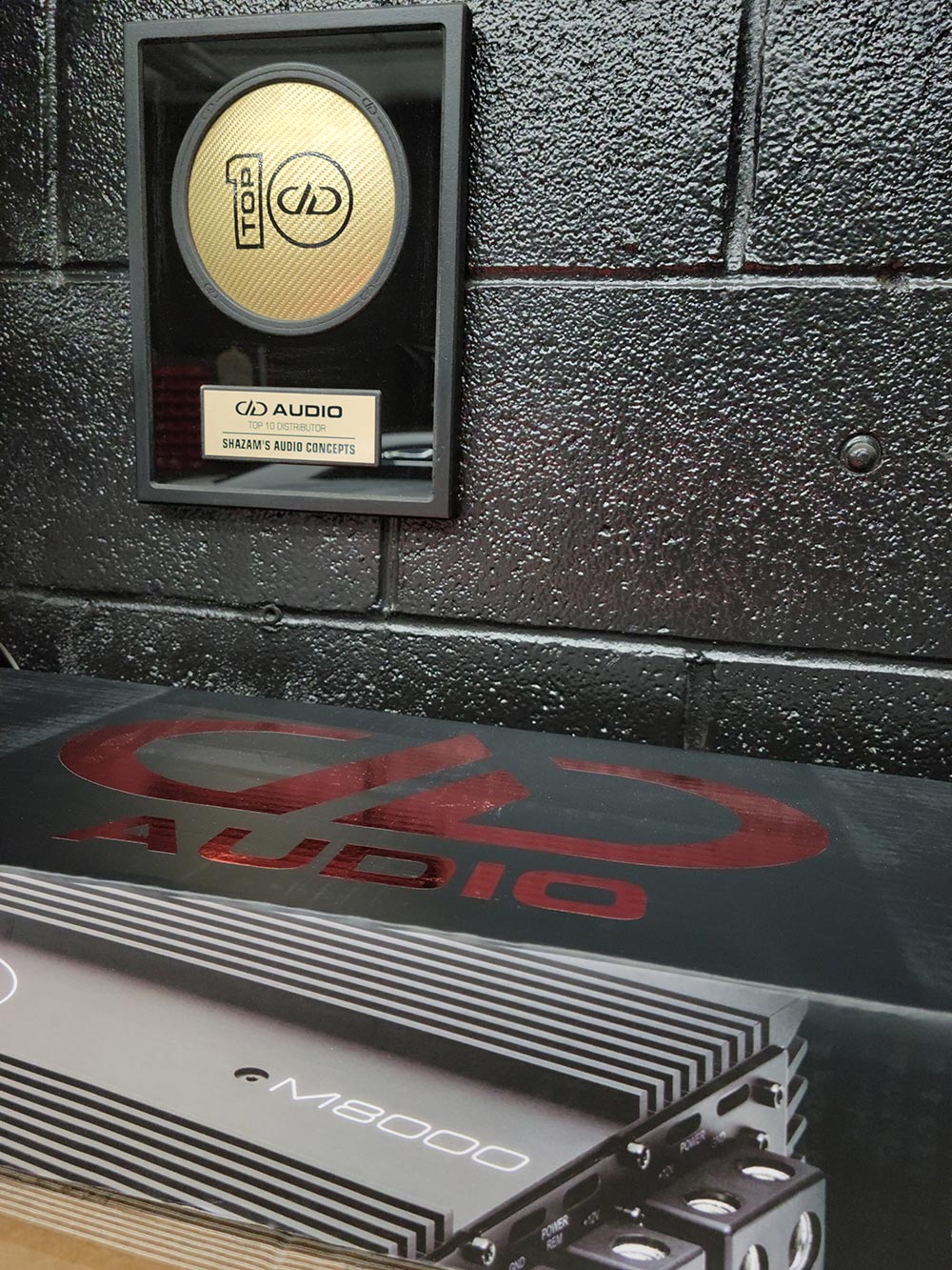 Photo of Shazam's Top Ten DD Dealer plaque hanging in shop