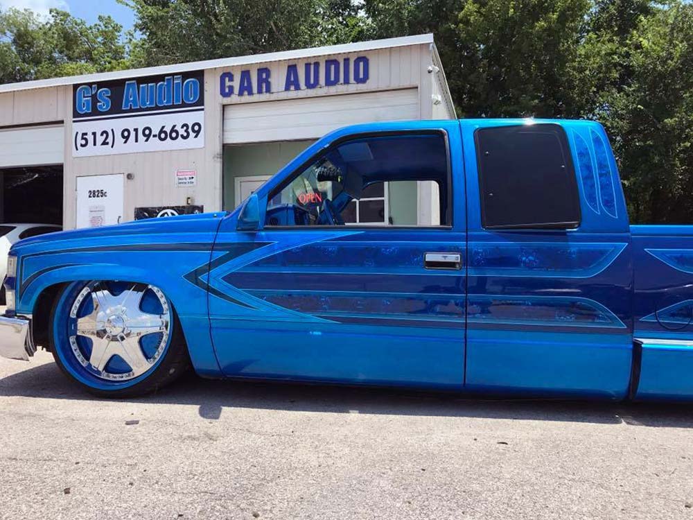 Photo of G Audio store front with custom blue pickup in shot