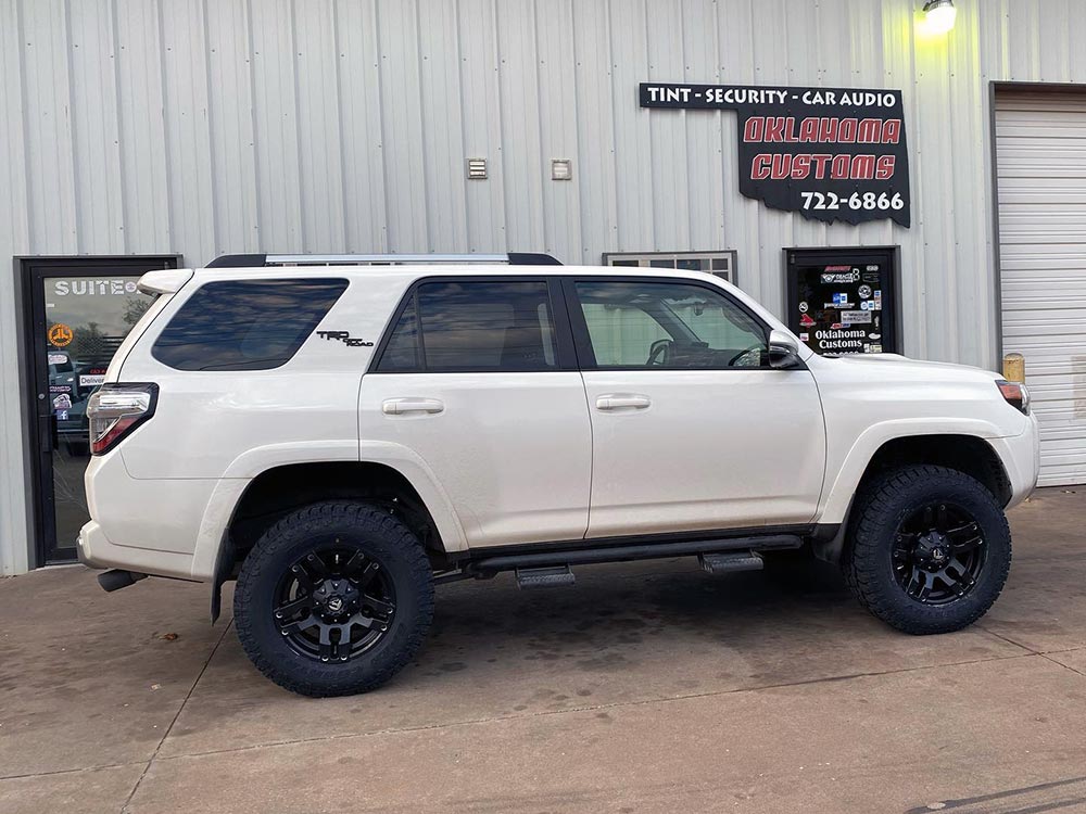 Photo of Oklahoma Customs store front with customized SUV in shot